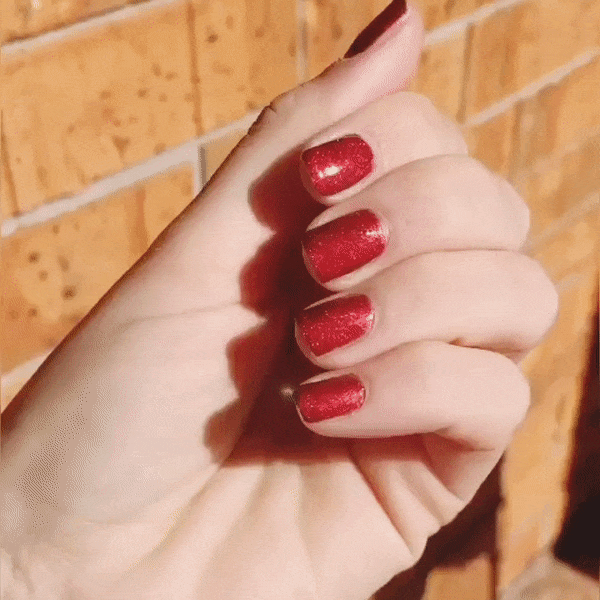 Nails showing dark rich shade with metallic effect